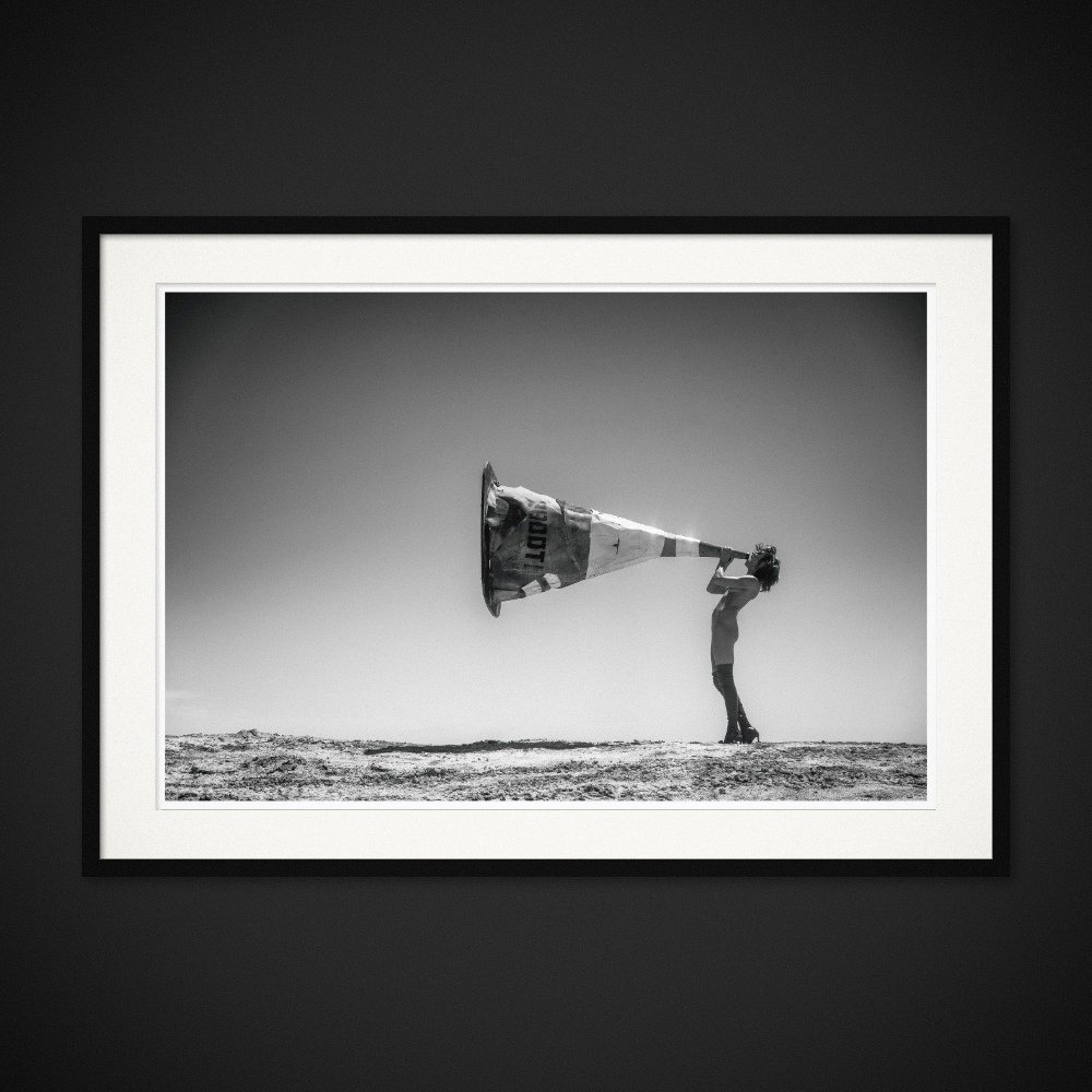 Cone Of Silence — A traffic cone becomes an oversized mouthpiece facing the horizon. Framed edition by Albert Pocej.