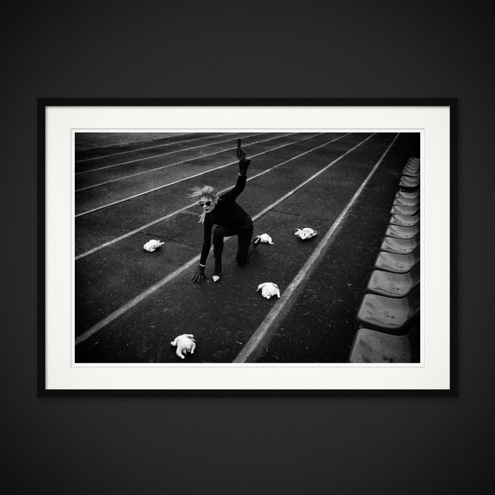 Fowl Play — A starting pose, a raised pistol and chickens on a running track. Framed edition by Albert Pocej.